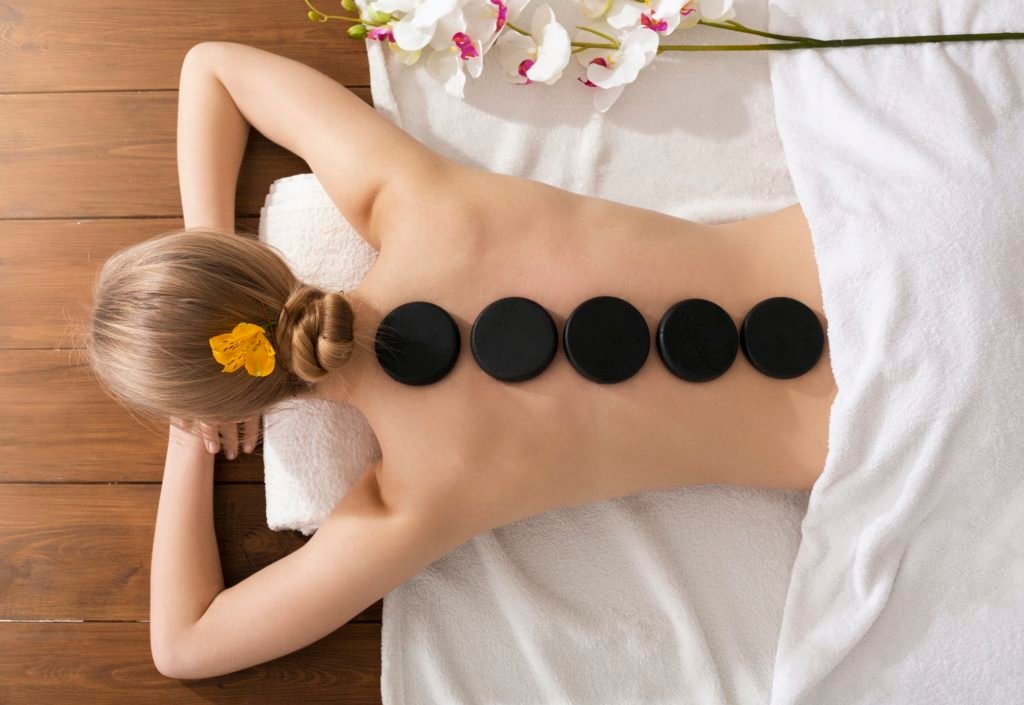 Spa stone massage concept. Girl on massage table